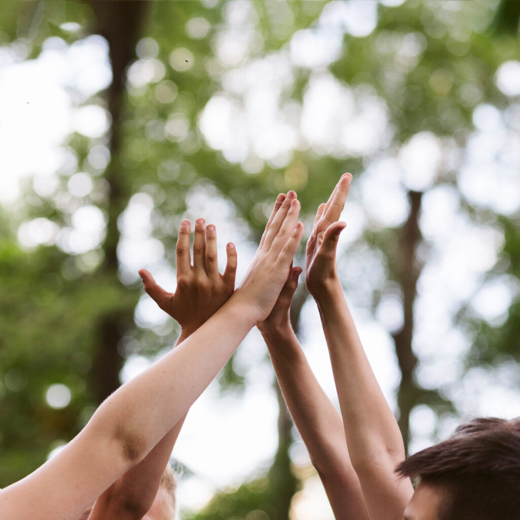 Dirigeant ou manager d’entreprise exprimant sa satisfaction et sa motivation après avoir intégré la RSE, mains levées, symbole de succès et d’engagement durable